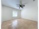 Bright, empty bedroom with large window and ceiling fan at 9095 Palos Verde Dr, Orlando, FL 32825