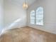 Bright dining room with arched windows, chandelier, and tile floors at 9095 Palos Verde Dr, Orlando, FL 32825