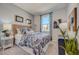 Bedroom with blue floral bedding, wicker headboard, and patterned curtains at 10152 Huntingnet Way, Leesburg, FL 34748