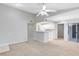 Living area with breakfast bar, neutral carpet, and white kitchen at 1029 S Hiawassee Rd # 2421, Orlando, FL 32835