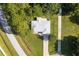 High angle aerial view of the roof and property, showing trees and a driveway at 1469 Swan Pl, Kissimmee, FL 34759