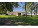 Spacious backyard with lush green lawn and mature trees at 1469 Swan Pl, Kissimmee, FL 34759