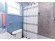 Modern bathroom featuring a granite countertop, tiled shower, and blue-grey walls at 1469 Swan Pl, Kissimmee, FL 34759