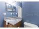 Bathroom interior with blue walls, granite countertop, and white sink at 1469 Swan Pl, Kissimmee, FL 34759