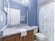 Clean bathroom with granite countertop, wooden cabinets, and shower/tub combo at 1469 Swan Pl, Kissimmee, FL 34759