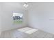 Bright, empty bedroom with large window and tile flooring at 1469 Swan Pl, Kissimmee, FL 34759