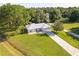Slightly elevated view of a single-story house with a lush green lawn at 1469 Swan Pl, Kissimmee, FL 34759