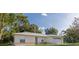 Front exterior view of the home with large windows and landscaping at 1469 Swan Pl, Kissimmee, FL 34759