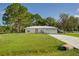 Front view of the house with a driveway and green lawn at 1469 Swan Pl, Kissimmee, FL 34759