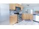 Modern kitchen with stainless steel appliances, granite countertops, and tile backsplash at 1469 Swan Pl, Kissimmee, FL 34759