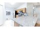Bright and airy kitchen with granite countertops, stainless steel appliances, and breakfast bar at 1469 Swan Pl, Kissimmee, FL 34759