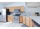 Well-appointed kitchen with stainless steel appliances, granite countertops, and a breakfast bar at 1469 Swan Pl, Kissimmee, FL 34759