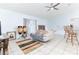 Comfortable living area with white sofa, vibrant rug, and open access to the kitchen at 1469 Swan Pl, Kissimmee, FL 34759