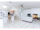 Spacious living room open to the kitchen with tile floors and high ceilings at 1469 Swan Pl, Kissimmee, FL 34759