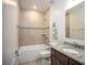 Guest bathroom with tiled shower, vanity with granite top and neutral colors at 1664 Andover Ridge Dr, Deland, FL 32720