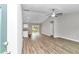 Open-concept living area with wood-look flooring, ceiling fan, and access to the kitchen and dining area at 199 Juniper Way, Ocala, FL 34472