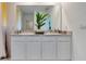 Stylish bathroom with a double vanity, contemporary fixtures, and a large mirror at 2105 Pigeon Plum Dr, Haines City, FL 33844