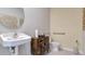 Modern bathroom with pedestal sink, wooden vanity, and accessibility features at 2105 Pigeon Plum Dr, Haines City, FL 33844
