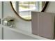Entryway shelf with decorative books, mirror, and small potted plant at 2105 Pigeon Plum Dr, Haines City, FL 33844
