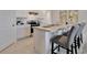 Contemporary kitchen featuring white cabinetry, stainless steel appliances, and an island with seating at 2105 Pigeon Plum Dr, Haines City, FL 33844