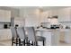 Bright white kitchen with an island and bar seating for casual dining at 2105 Pigeon Plum Dr, Haines City, FL 33844
