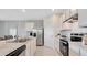Modern kitchen with stainless steel appliances, white cabinetry, and an island at 2105 Pigeon Plum Dr, Haines City, FL 33844