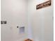 Laundry room with white walls, wall decor, and washer/dryer hookups at 2105 Pigeon Plum Dr, Haines City, FL 33844