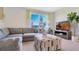 Cozy living room with a comfortable sectional sofa, large windows, and stylish decor at 2105 Pigeon Plum Dr, Haines City, FL 33844