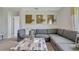 Modern living room with a comfortable sectional sofa and a contemporary art piece at 2105 Pigeon Plum Dr, Haines City, FL 33844