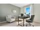 Stylish home office with a comfortable gray chair, a desk, and a Roman numeral wall clock at 2105 Pigeon Plum Dr, Haines City, FL 33844