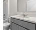 Modern bathroom with gray vanity, white countertop, and chrome fixtures at 2109 Pigeon Plum Dr, Haines City, FL 33844