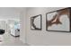 Modern hallway with artwork and entryway to the living room at 2109 Pigeon Plum Dr, Haines City, FL 33844