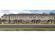 Attractive row of townhouses with gray siding, dark shingle roofs, and landscaped yards at 2765 Flushing Dr, Apopka, FL 32703