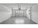 Two-car garage with white brick walls and gray epoxy floors at 2765 Flushing Dr, Apopka, FL 32703