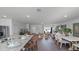 Open-concept kitchen and living area with granite countertops, stainless steel appliances, and wood-look flooring at 2765 Flushing Dr, Apopka, FL 32703