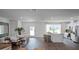Open-concept living and dining area with kitchen view, wood-look flooring, and access to backyard at 2765 Flushing Dr, Apopka, FL 32703