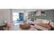 Open living area with comfy seating, entertainment center, and view towards the kitchen and staircase at 2765 Flushing Dr, Apopka, FL 32703