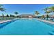 Community pool with cabana, lounge chairs, and palm trees at 2765 Flushing Dr, Apopka, FL 32703