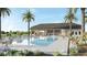 Community pool with a cabana, lounge chairs, and lush landscaping at 2765 Flushing Dr, Apopka, FL 32703