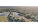 Aerial view of a residential community with houses surrounding a lake at 2920 Orangebud Dr, Kissimmee, FL 34746