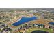 Aerial view of a lake surrounded by homes and open land in a residential neighborhood at 2920 Orangebud Dr, Kissimmee, FL 34746