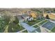 An aerial view of a house with a two-car garage, landscaped yard, and nearby pond at 2920 Orangebud Dr, Kissimmee, FL 34746