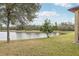 Scenic backyard with tranquil water views and mature trees at 2920 Orangebud Dr, Kissimmee, FL 34746