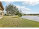 Spacious backyard with lush green grass and waterfront view at 2920 Orangebud Dr, Kissimmee, FL 34746