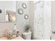 Bathroom with vanity, toilet, shower, and decorative wall mirrors at 2920 Orangebud Dr, Kissimmee, FL 34746