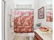 Clean bathroom with shower/tub combo, vanity, and decorative accents at 2920 Orangebud Dr, Kissimmee, FL 34746