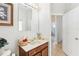 Bathroom vanity with mirror, light fixture, and doorway to adjacent room at 2920 Orangebud Dr, Kissimmee, FL 34746