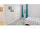 Bright bedroom with closet doors, windows with blue curtains, and a bed at 2920 Orangebud Dr, Kissimmee, FL 34746