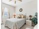 Cozy bedroom with bed, nightstands, window, and ceiling fan at 2920 Orangebud Dr, Kissimmee, FL 34746