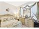 Bedroom featuring a bed, dresser with mirror, and nightstand at 2920 Orangebud Dr, Kissimmee, FL 34746